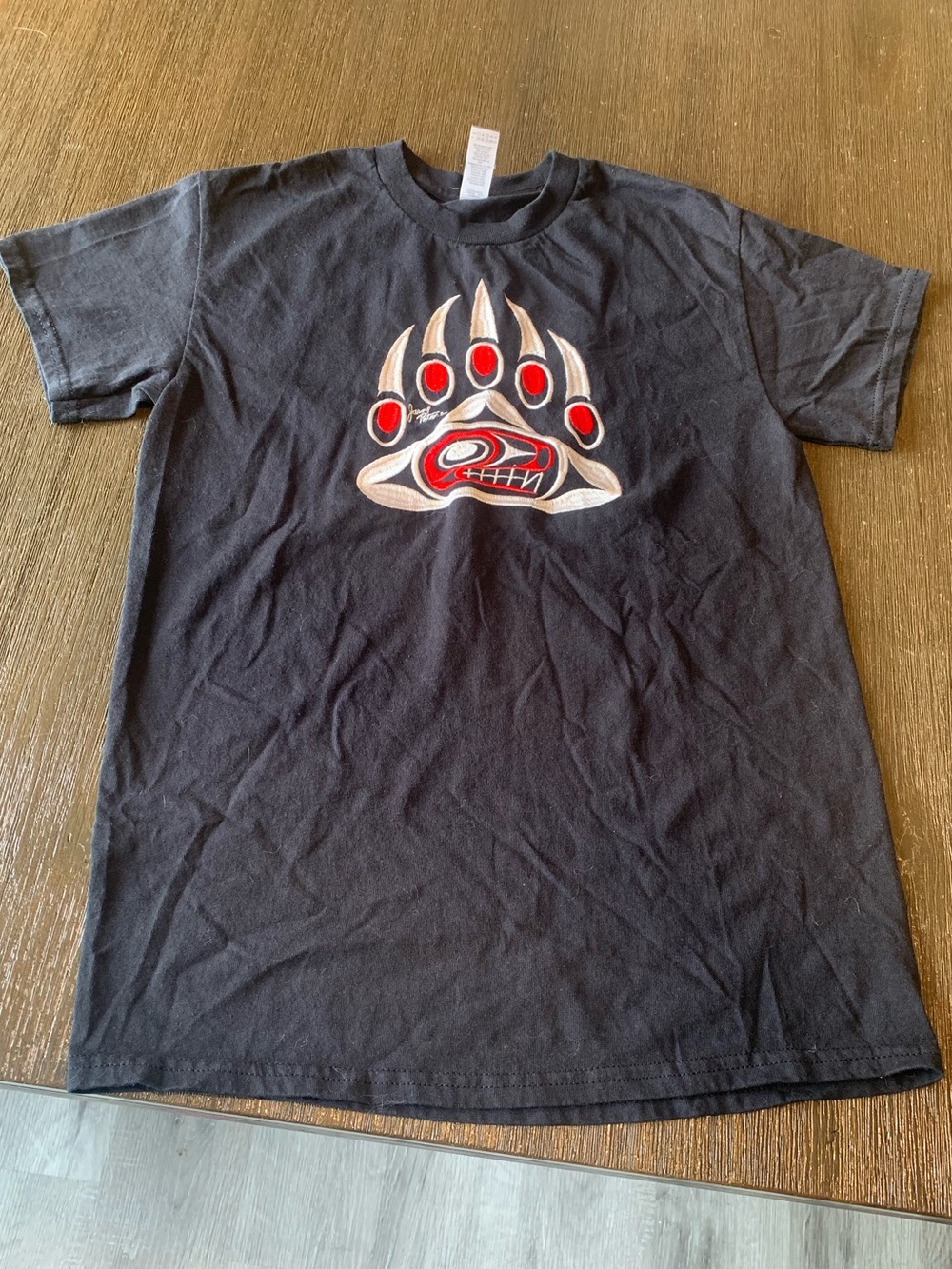 Black Short-Sleeve Graphic Tee with Red and Cream Bear Paw Motif